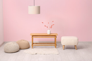 Interior of modern living room with coffee table and poufs