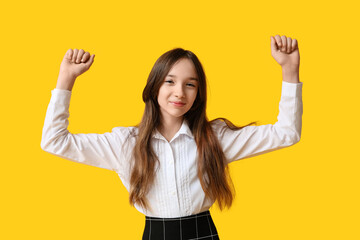 Cute schoolgirl on yellow background