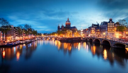 Naklejka premium amsterdam panoramic view of the downtown of amsterdam a blue evening time and the serene reflection of lights in the water europe netherlands holland amsterdam