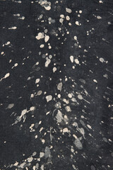 Fototapeta premium A black and white photo of a black and white shirt with white splatters on it