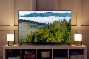TV set with mountain landscape on screen in room