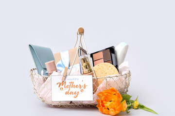 Basket with cosmetic gifts and flower for Mother's Day on isolated white background © Pixel-Shot