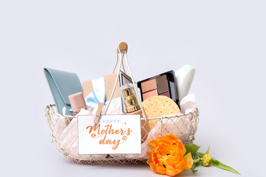 Basket with cosmetic gifts and flower for Mother's Day on isolated white background