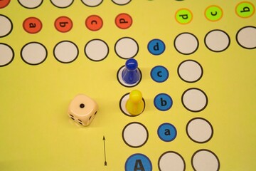 Game Clash in Progress – Yellow vs. Blue Pawns on Ludo Board