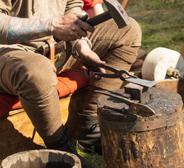 forging metal by hand in nature.