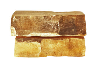 Golden limestone blocks stacked together for construction use in a natural setting with sunlight highlighting their texture, cut out
