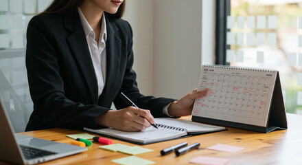 An executive reviewing schedules in an office, emphasizing time management and productivity through calendar planning