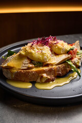 Delicious Eggs Benedict with Smoked Chicken, Fresh Tomato, Creamy Sauce, Crisp Vegetables on Sourdough Bread, Breakfast Culinary Delight Concept