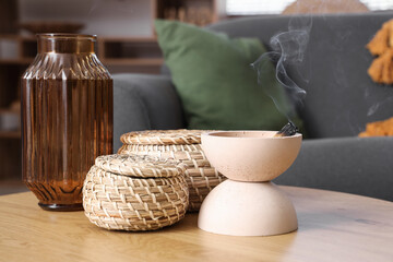 Bowl with Palo Santo, baskets and vase on table in living room, closeup