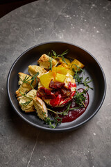 Gourmet Plate with Bread, Roasted Vegetables, Red Sauce, and Herbs on Grey Stone Table, culinary art concept