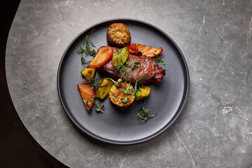 Gourmet roasted vegetables with succulent beef steak on elegant plate, culinary delight composition