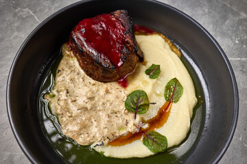 Gourmet Steak Dish With Mashed Potatoes Creamy Sauce Garnished With Fresh Herbs On Black Plate Culinary Delight Concept