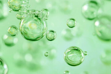 Close up abstract clear green serum bubbles in cosmetic gel