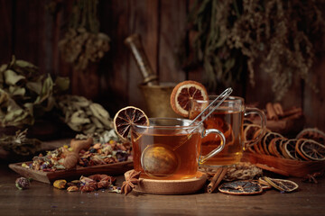 Cups of herbal tea with various dried herbs, flowers, and spices.