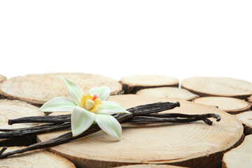 Aromatic vanilla pods and flower on table against white background