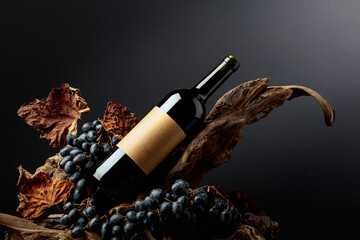 Bottle of red wine with empty label on a old snags.