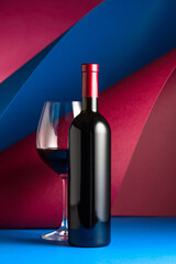 Bottle and glass of red wine.