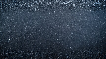 Obraz premium Dark pavement texture with rough edges, showing signs of wear and repair and sparkles
