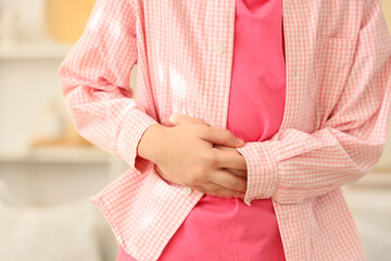 Teenage girl with appendicitis at home, closeup