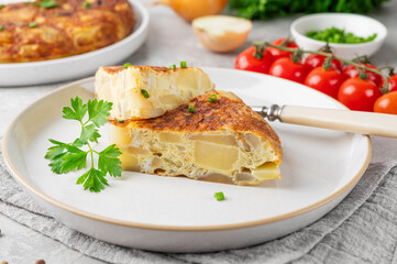 Spanish omelette tortilla with potatoes and onion on a stone background. Spanish cuisine. Top view.