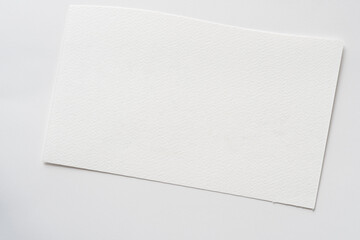 blank white watercolor paper on a sheet of drawing paper with slight tooth