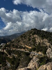 The sea and mountains are landscaped with clouds and sunny weather. Mirador de Cerro gordo