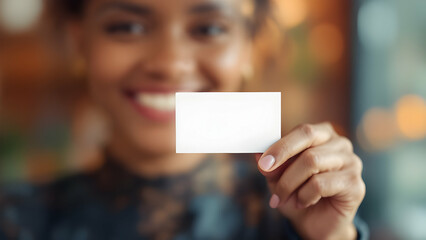 Smiling professional holding a business card.