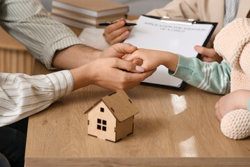 Couple holding hands with girl and social worker at table in office, closeup. Adoption concept