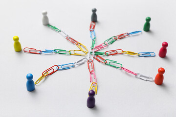 Figures with chains on light background. Link concept