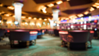 A blurry image of a casino interior with multiple gaming tables and slot machines, featuring an exciting and vibrant atmosphere filled with lights and energy.