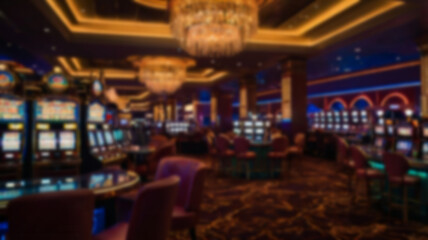A blurry image of a luxurious casino interior with rows of tables and slot machines, creating an exciting and glamorous atmosphere for entertainment.
