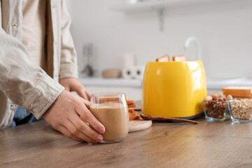Young man with toaster, toasts and peanut butter in kitchen, closeup