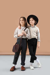 Stylish girls hugging on color background