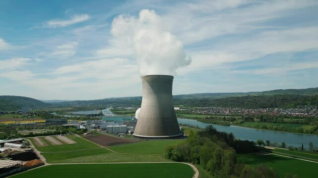 Working nuclear power plant in Switzerland with cooling pipe and smoke