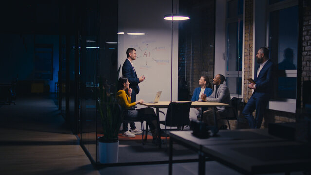 Diverse business team discussing artificial intelligence in a modern office at night. Concept of teamwork, corporate strategy, and AI technology in professional settings.