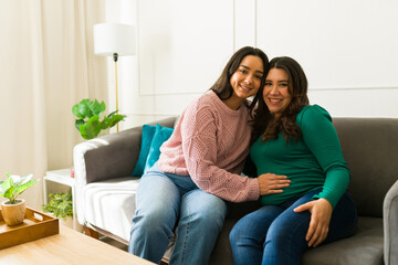 Doula comforting and assisting pregnant woman during a home visit, providing emotional and physical...
