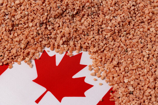 Potash potassium fertilizer with Canada flag. Farm fertilizer production, supply and agriculture tariffs concept.