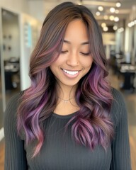 Fototapeta premium A stylist showcasing the final touches on a vibrant balayage hair color
