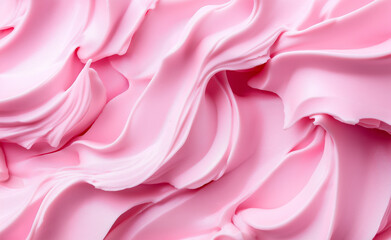Fototapeta premium A close-up of soft, swirled pink frosting, creating a smooth and creamy texture.