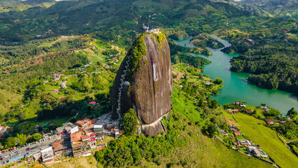 Aerial View of El Peñol Rock in Guatape, Antioquia, Colombia Surrounded by Lush Green Landscape and Lake
