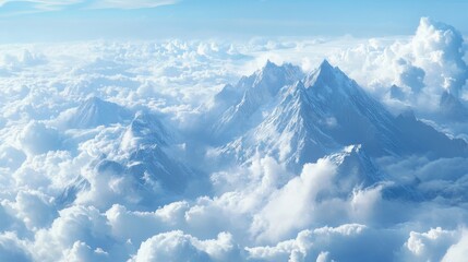 Aerial view of rugged mountain peaks piercing through a blanket of clouds