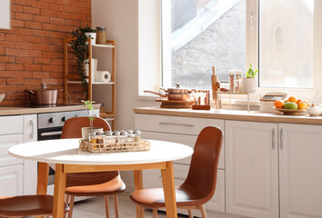 Interior of kitchen with counters, dining table and spices