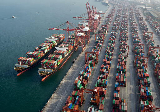 Huge container vessels line pier, container flow fueling commerce pathways, container bustle revealing advanced infrastructure for safe