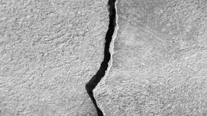 Vertical big crack on old stone wall, abstract image of cleft, background textured. Close-up. Copy...