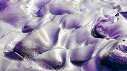 The photo captures the intricate patterns and textures of a clay riverbed at dawn. The light and...