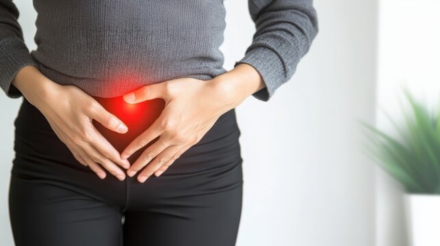 Woman suffering lower abdomen pain, gripping stomach with red area indicating cramping or digestive discomfort, wearing casual clothing