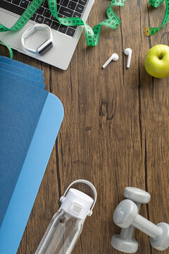 Fitness vertical equipment and wellness items arranged on a wooden background for healthy lifestyle inspiration