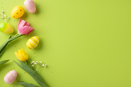 Vibrant photo of colorful easter eggs and tulips arranged on a green background, perfect for holiday-themed uses, celebrating spring, Easter decoration, and cheerful occasions