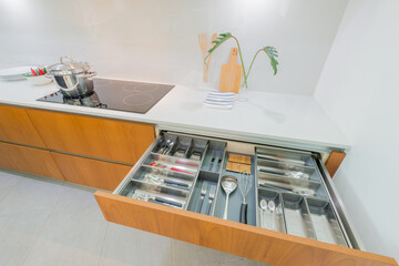 Modern Kitchen Drawer with Organized Cutlery and Cooking Utensils in Contemporary Interior Design