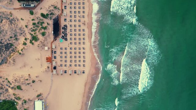 Drone breathtaking view of Sinemorets Beach, Bulgaria with shoreline umbrellas and green water